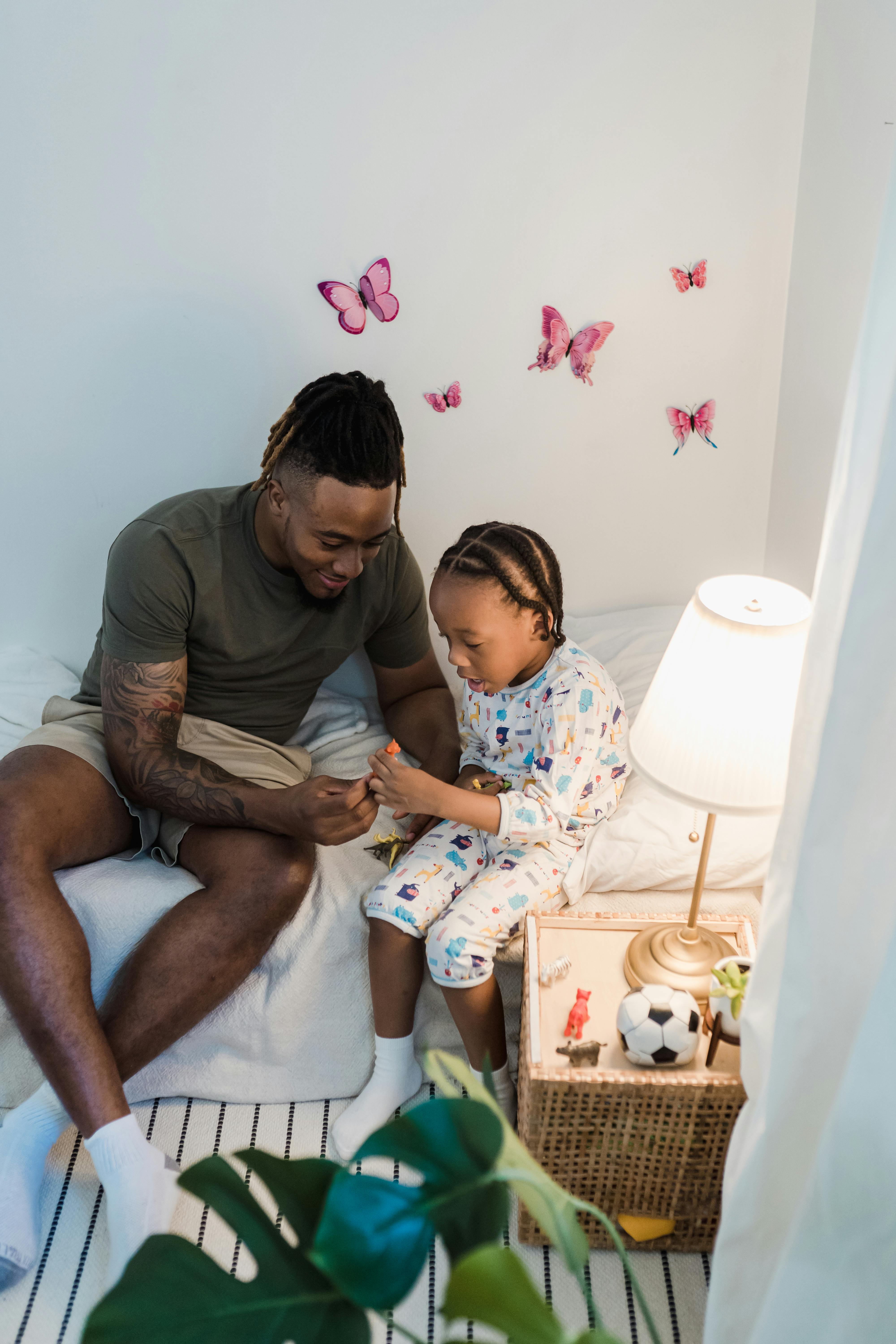 father and son playing with toys in the child room