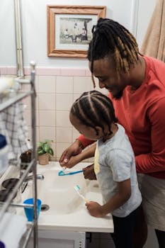 Dad and son bonding while brushing teeth at home, capturing a joyful morning moment.