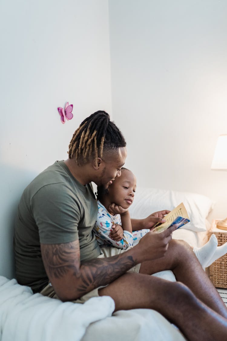 Father Reading A Bedtime Story To His Son 