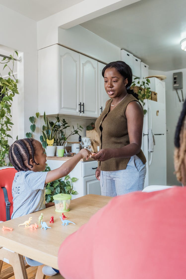 Mother And Daughter In Kitchen In Morning