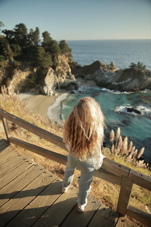 Back View of a Girl Looking at a Scenic Seacoast