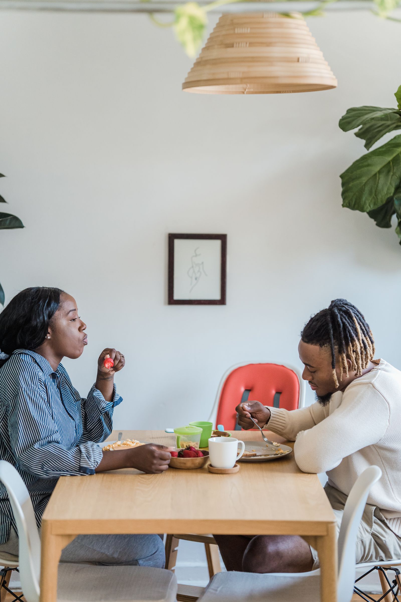 Two people sharing breakfast at a dining table