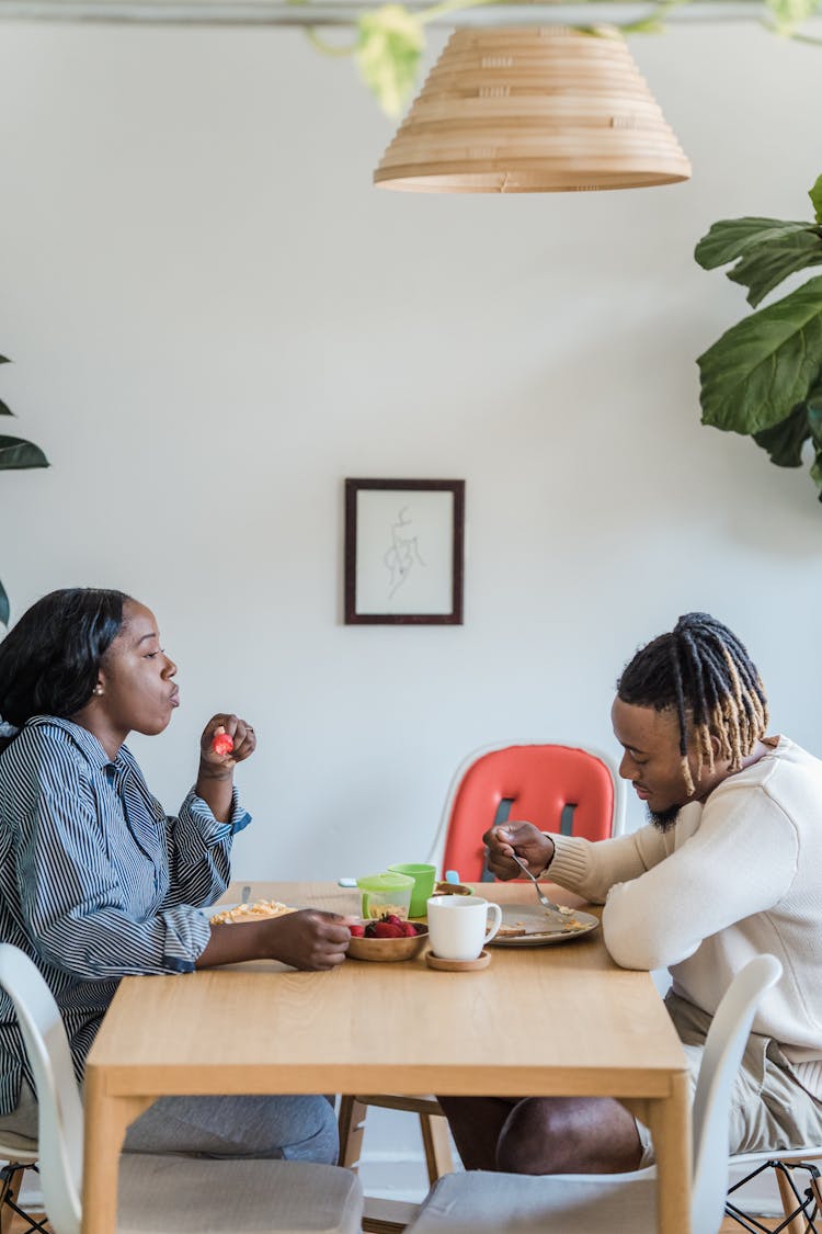 Couple Eating Breakfast At The Table 