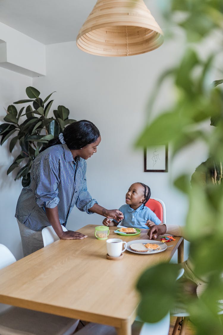 Mother And Son Talking During A Meal 