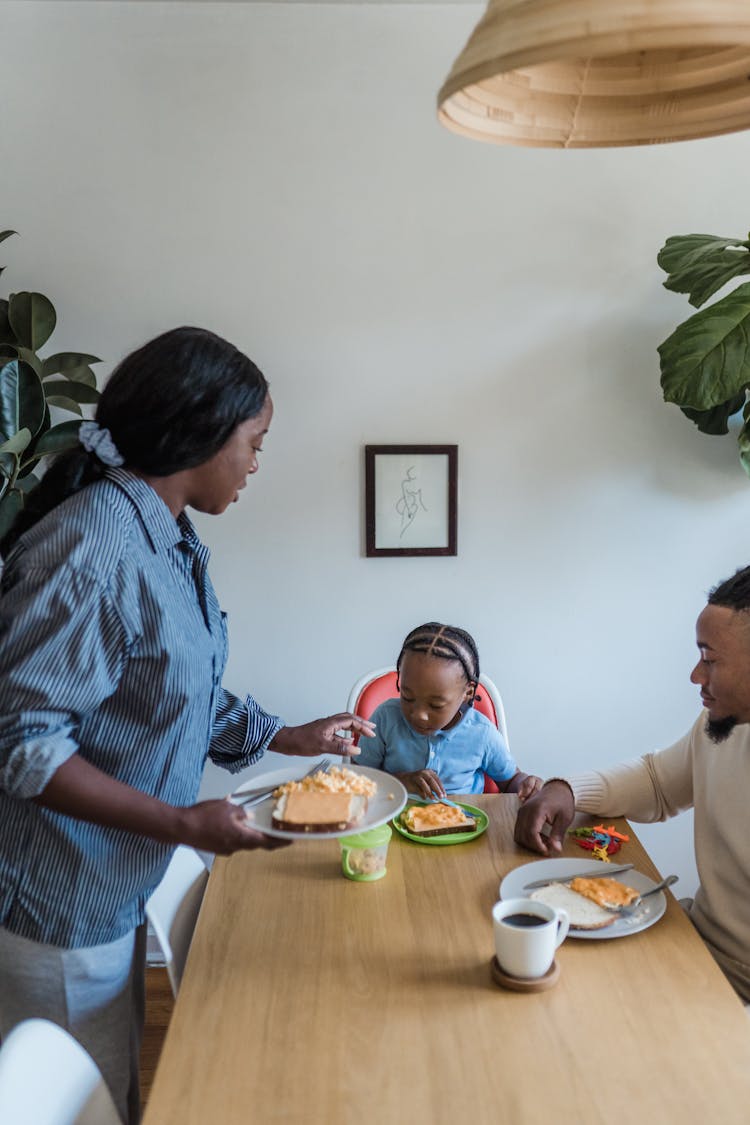 Family With Kid Eating Breakfast Together 