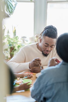 A family gathered indoors enjoying a meal together in a cozy dining area.