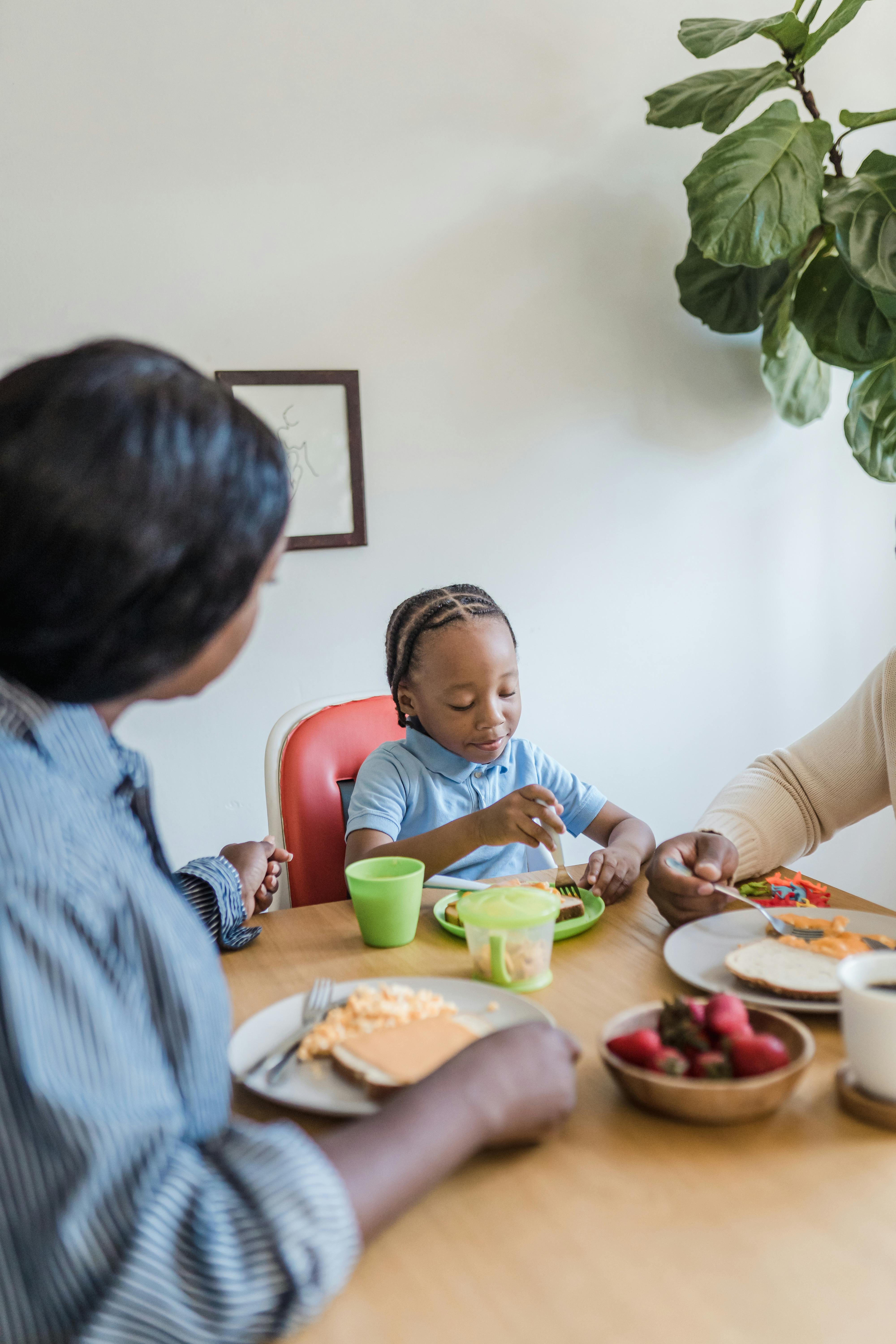 parents eating breakfast with a son at home