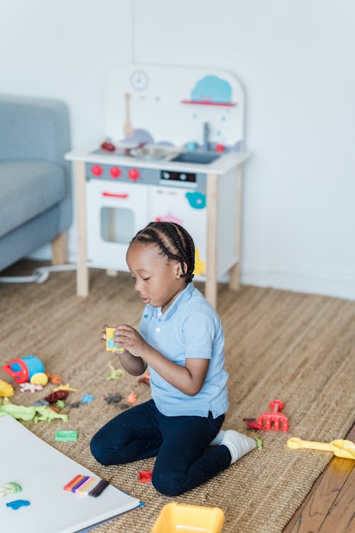 Free Little Boy Playing with His Toys at Home  Stock Photo