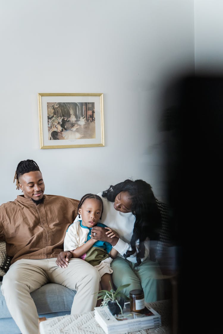 Family With A Son Watching TV At Home 