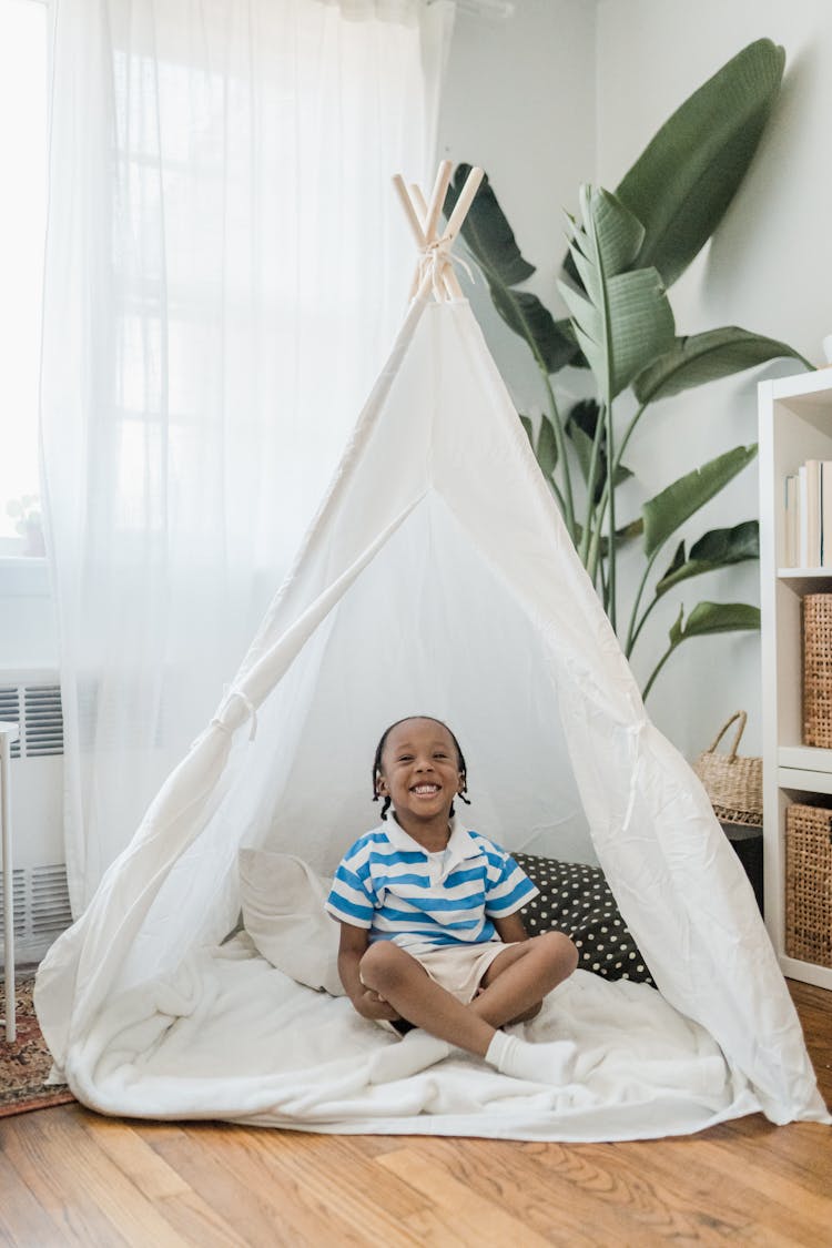 Smiling Little Boy Sitting In Indoor Tent