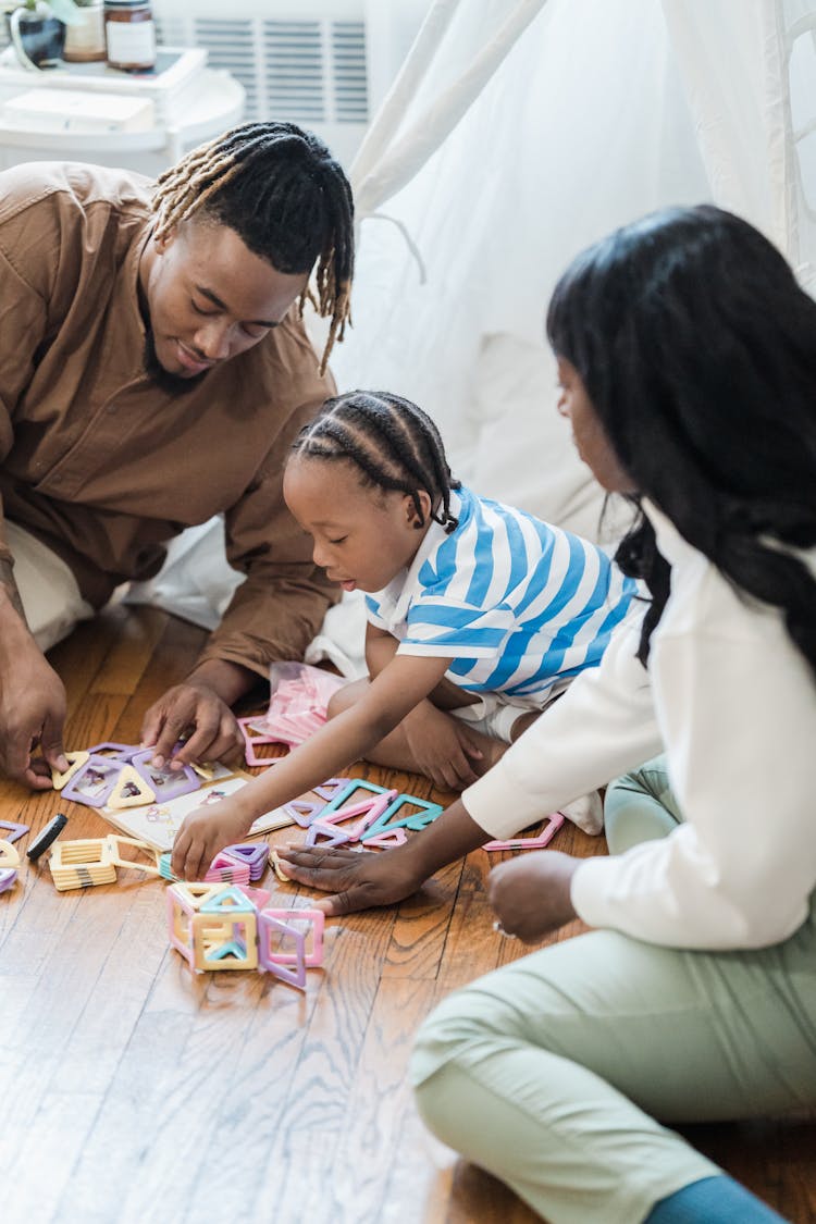 Parents Playing With Small Child