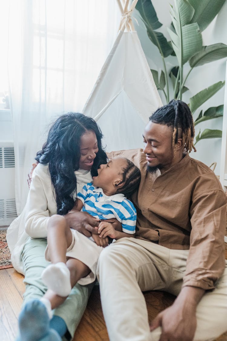 Happy Family With Child Relaxing At Home