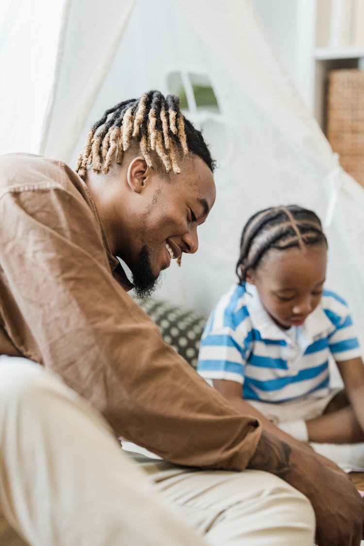 Father And Son Playing At Home 