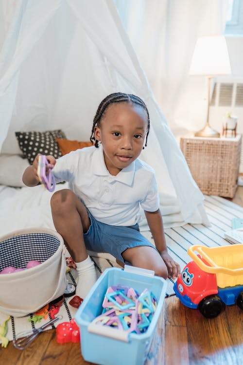 Little Boy in Playing with His Toys at Home 