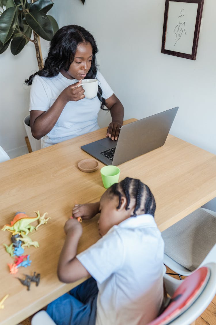 Child Playing With Toys While Mother Works