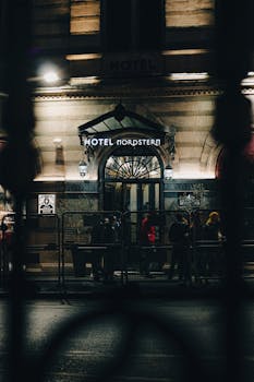 A view of the illuminated Hotel Nordstern entrance in Istanbul, captured during the night.