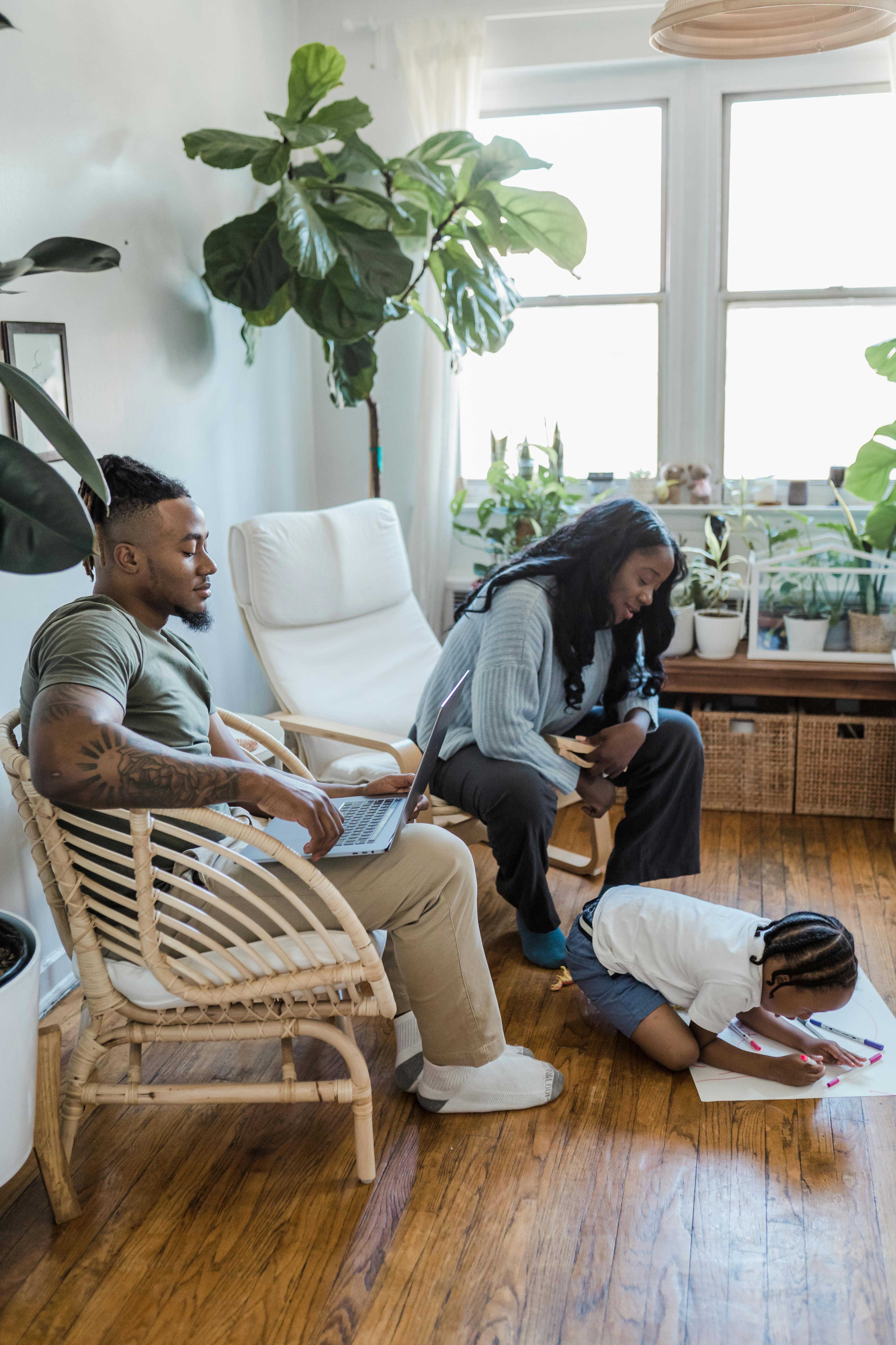 parents watching daughter draw on floor