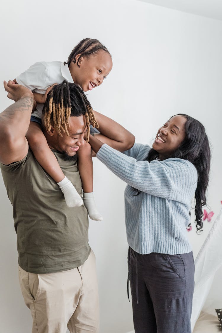 Mother Taking Daughter Off Of Father Shoulders