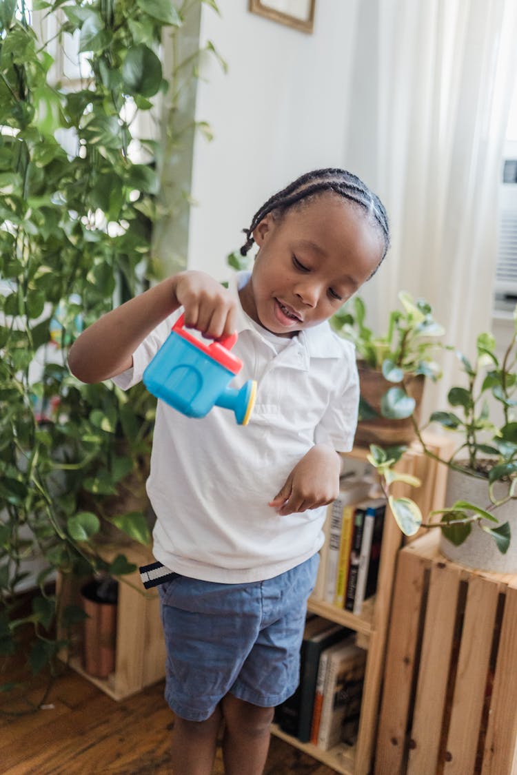 Happy Child Playing With Toy Watering Can