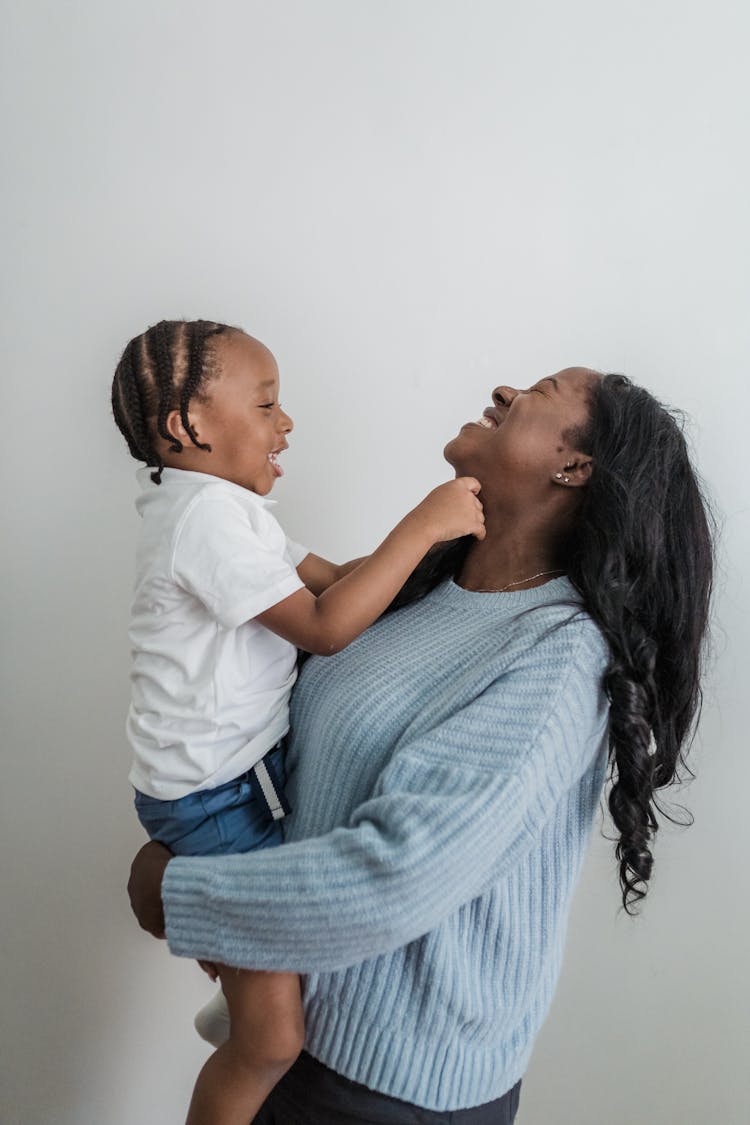 Mother Holding Small Child In Arms 