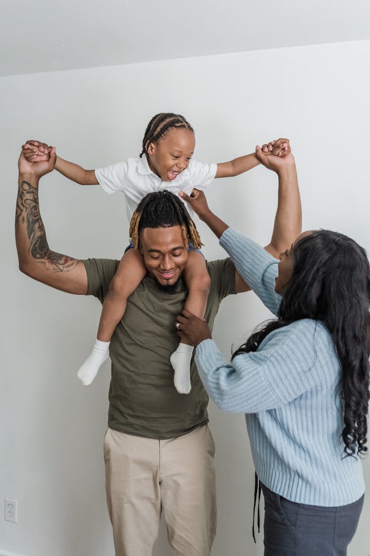 Daughter Sitting On Father Shoulders