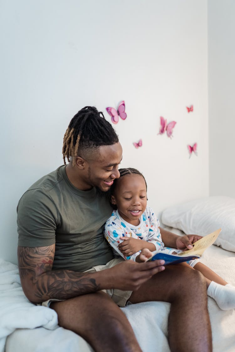 Father Reading Bedtime Story To Daughter