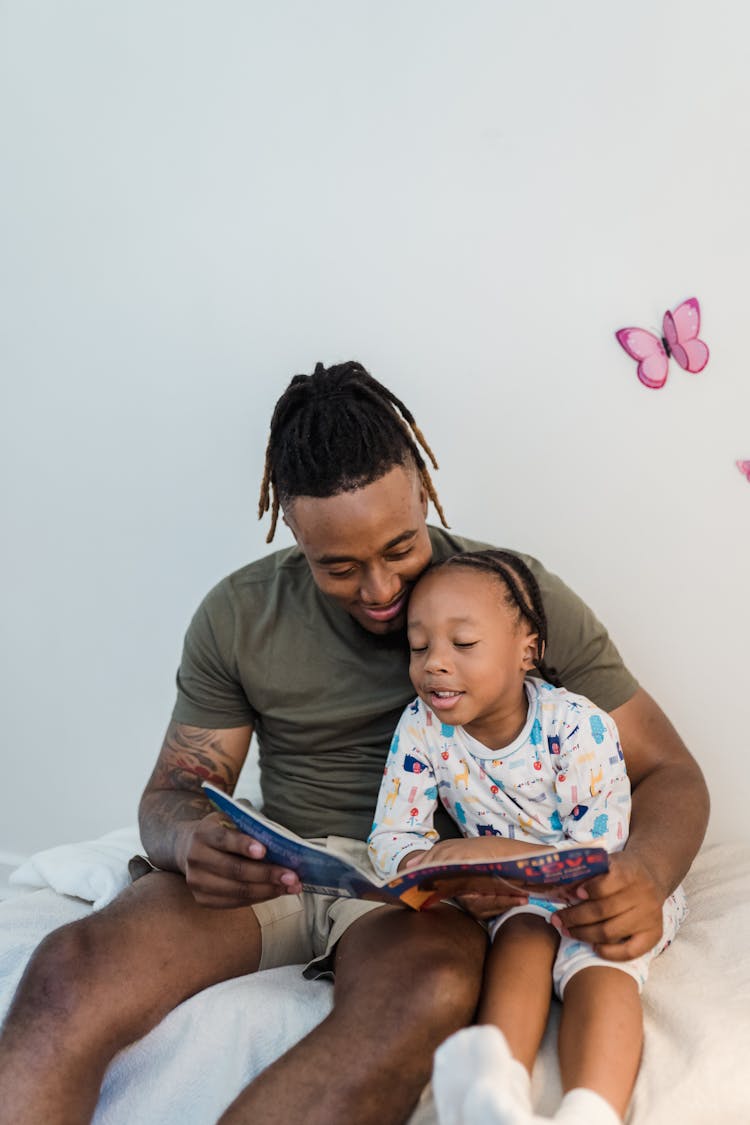 Father Teaching His Son To Read 