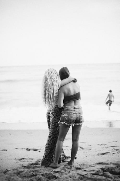 Back View of a Couple Standing on the Beach