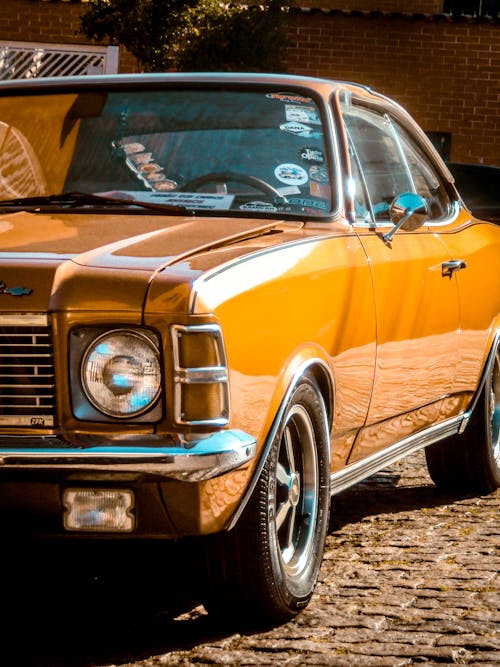 A Yellow Vintage Car Parked on the Street