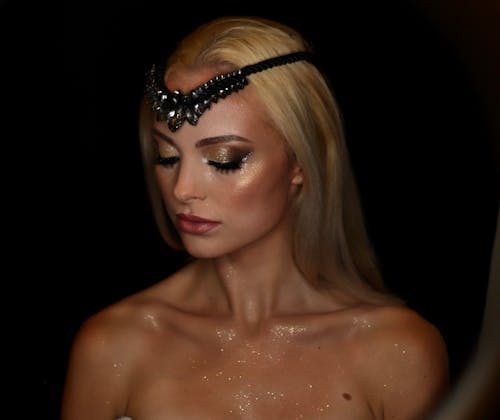 Woman With Black Beaded Hair Accessory Wearing Creative Make Up