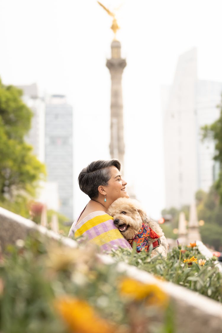 Woman Embracing Dog In Park