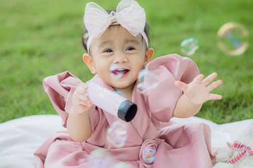 Free Close Up Photo of Toddler Playing with Soap Bubbles Stock Photo
