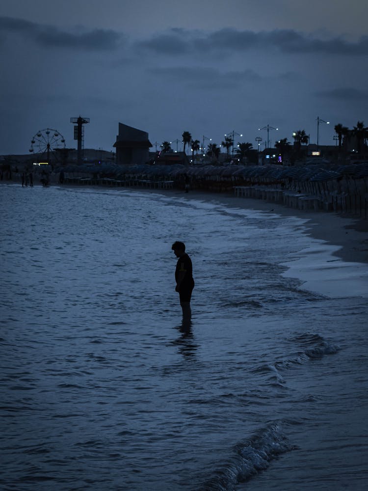 A Silhouette Of A Person On A Shore