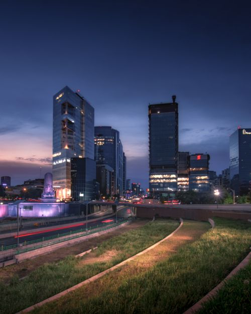 Free Captivating skyline of Mexico City at dusk showcasing vibrant high-rise buildings and city lights. Stock Photo