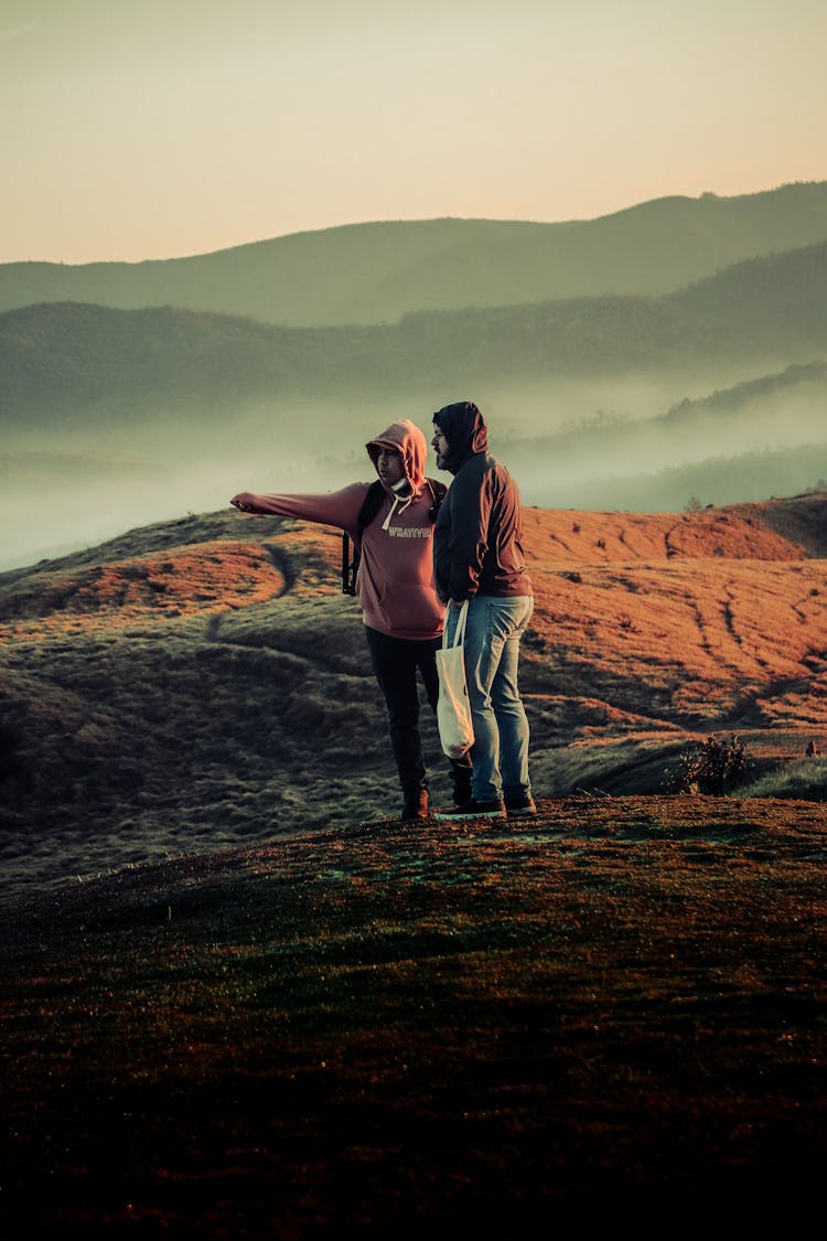 Men Standing On A Hill