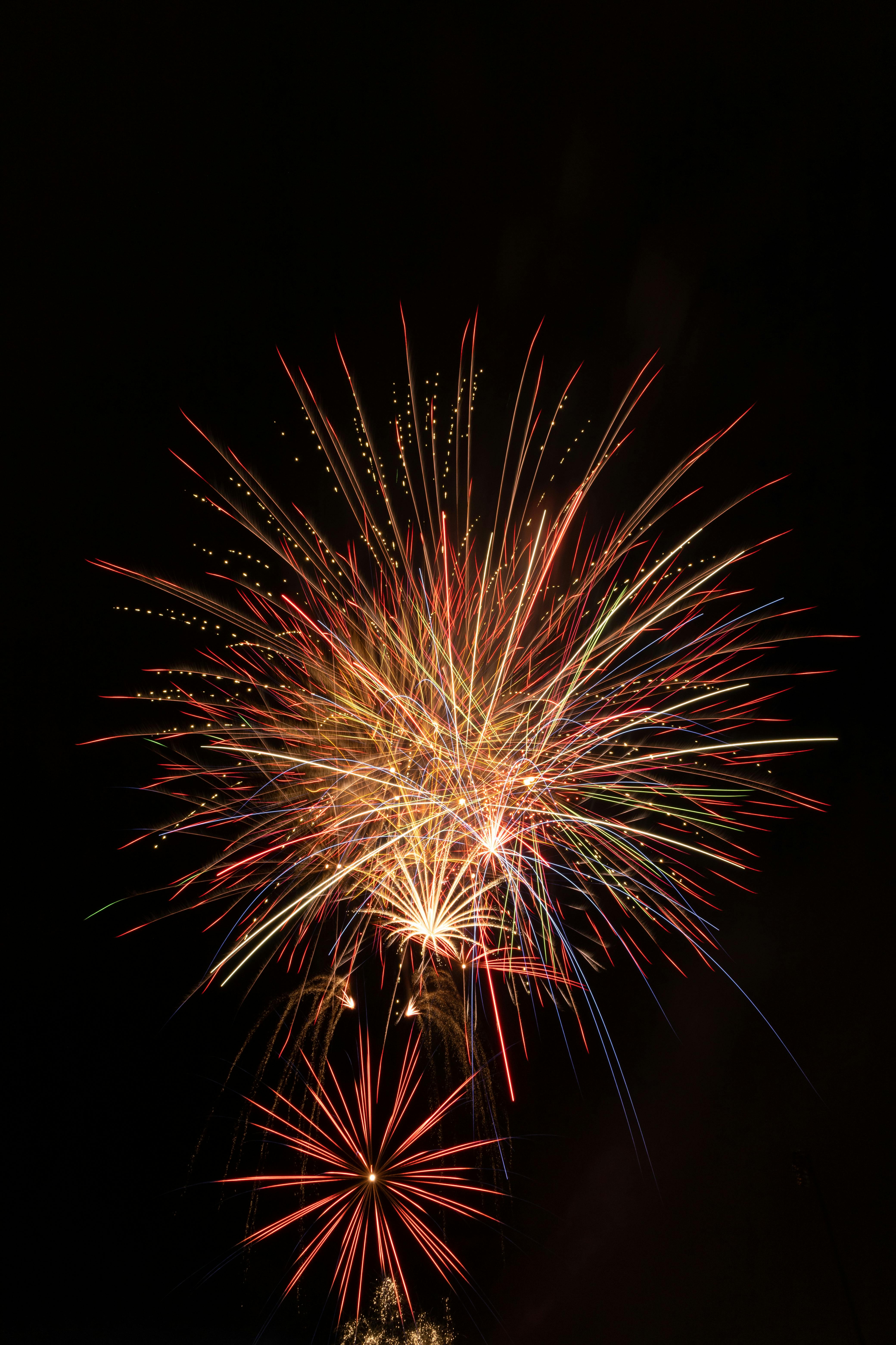 A dazzling array of fireworks explodes against a dark night sky, capturing the essence of celebration.