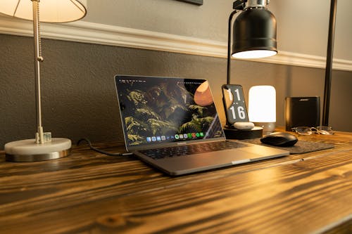 Free Open Laptop Lying on a Wooden Desk Stock Photo