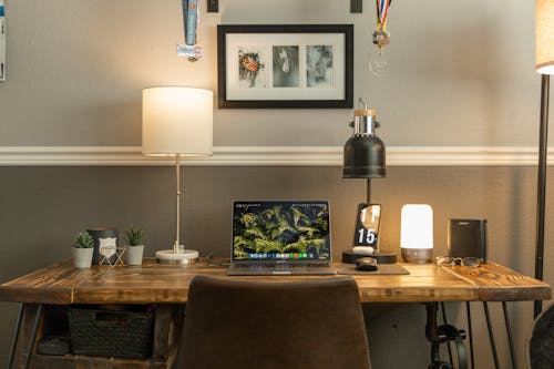 Desk Lamps and Open Laptop on a Wooden Desk