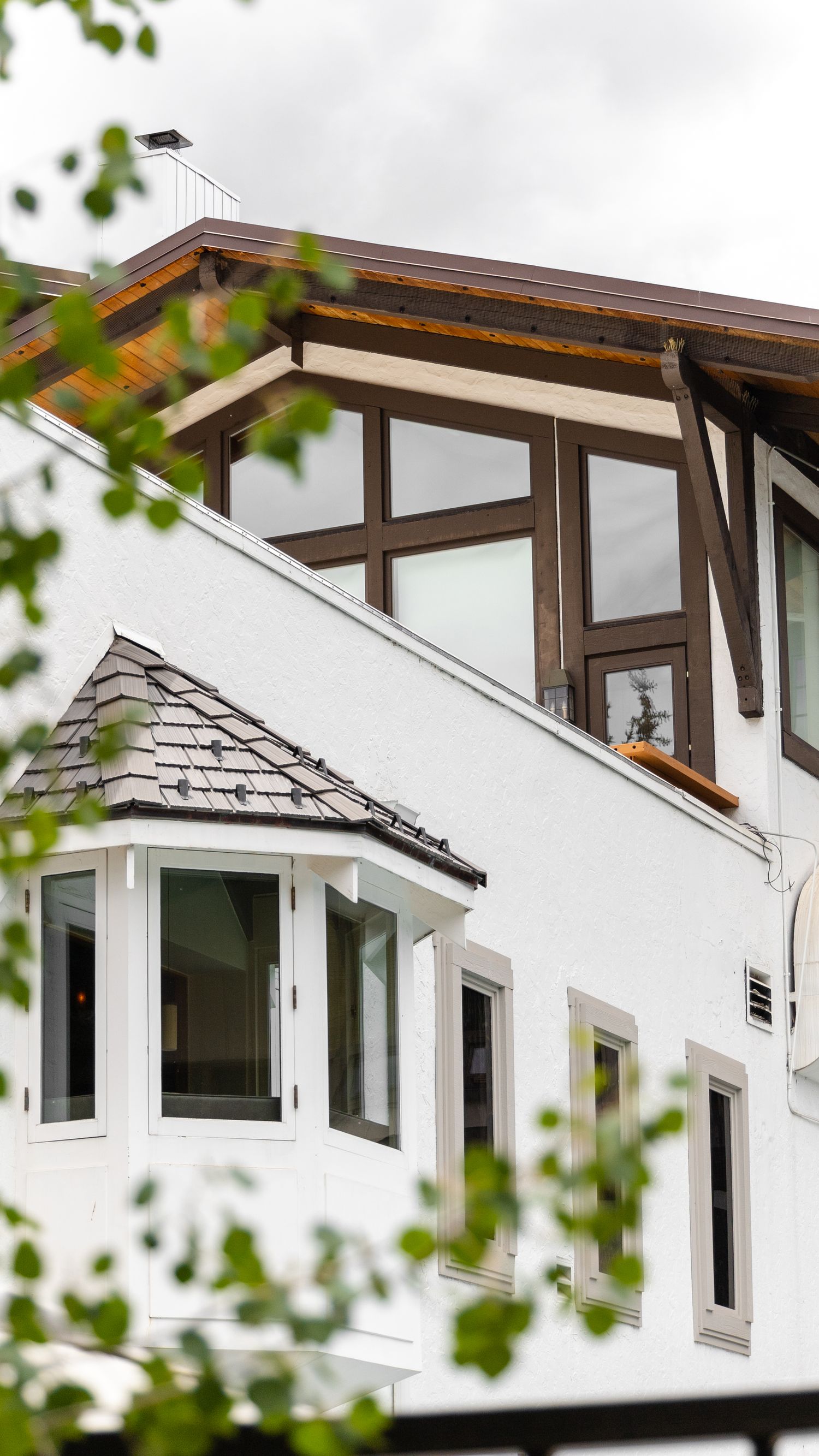 Residential exterior showing several large windows integrated with the facade