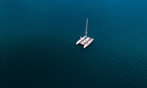 Aerial Photography of a White Yacht on the Blue Ocean