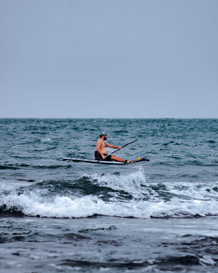 A Man Paddleboarding On The Sea