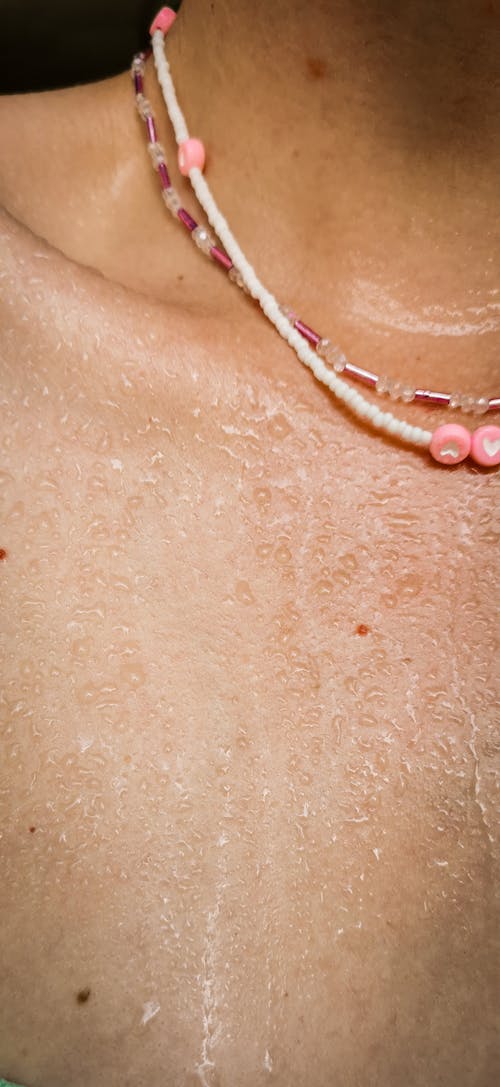 A Sweaty Person Wearing Pink Beaded Necklace