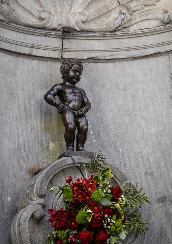 Statue of Man Holding Flower