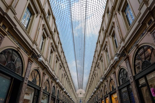 Interior of a historic shopping gallery with intricate architecture and glass ceiling.