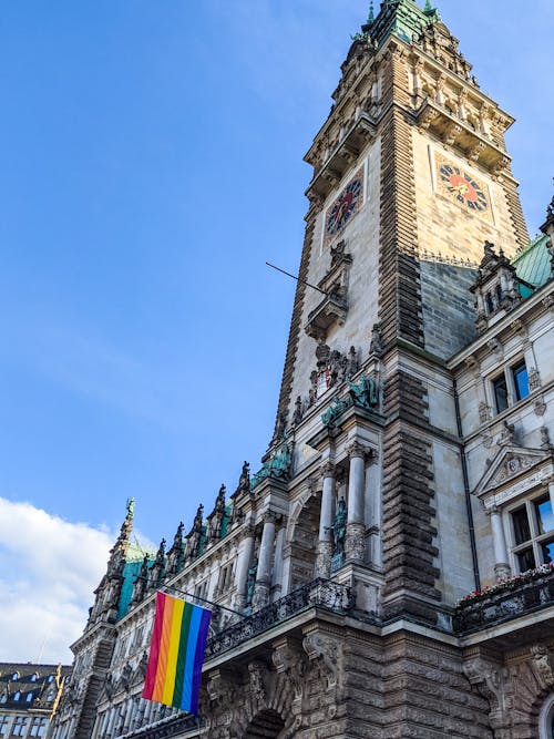 Rainbow Flag on Hamburg Town Hall Under Blue Sky