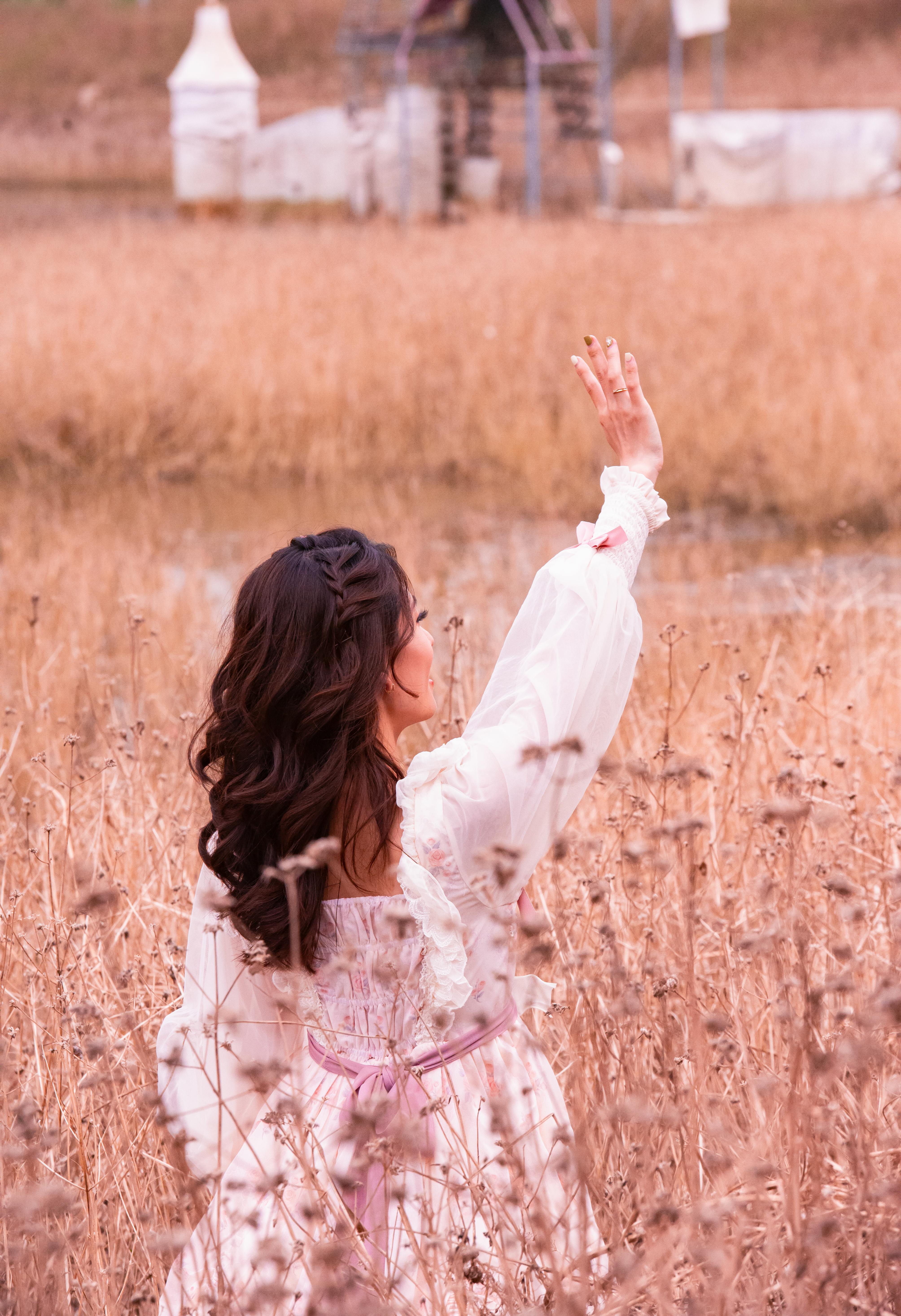 woman in a white dress on a field