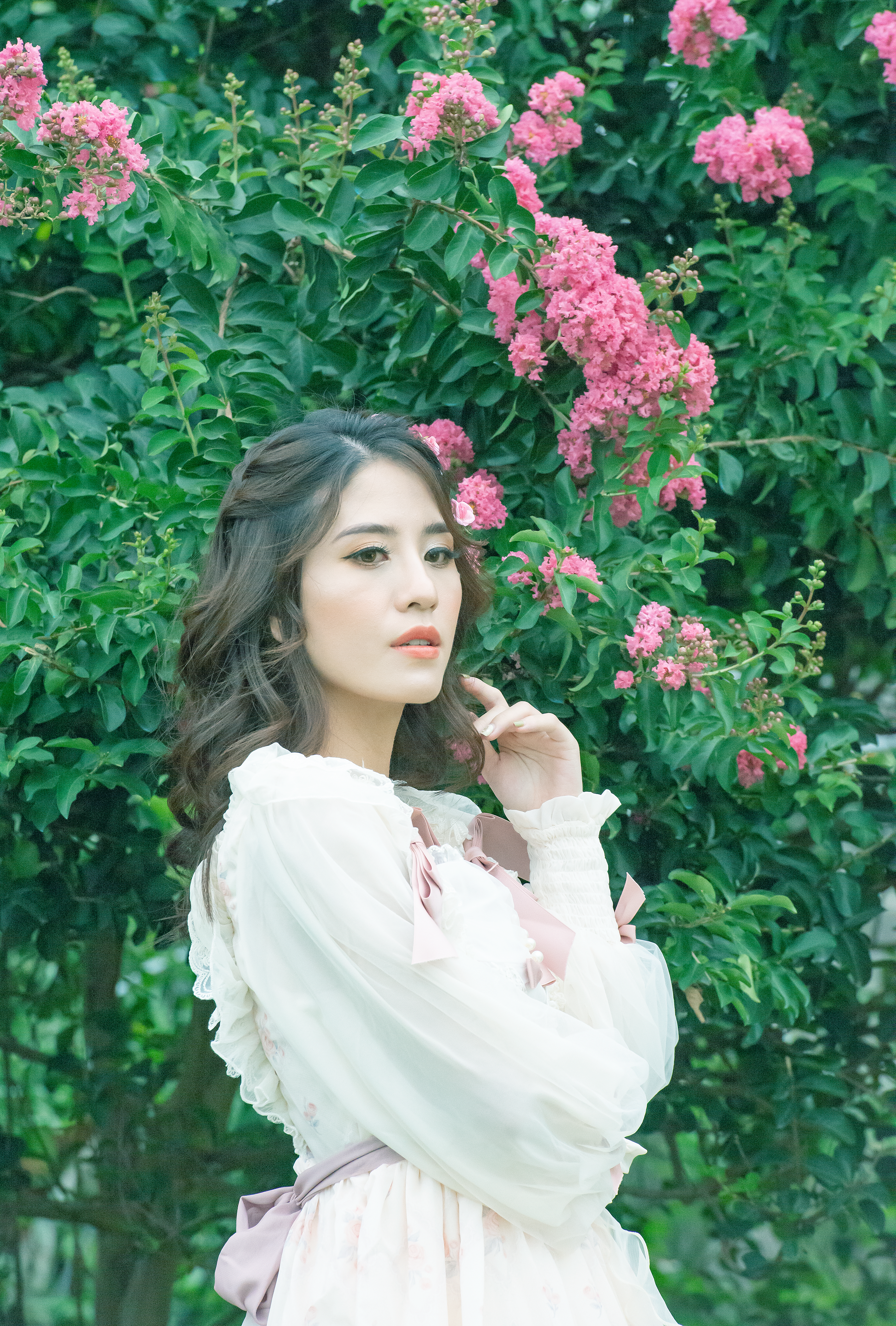 Beautiful Woman in White Dress Posing near Pink Flowers · Free Stock Photo