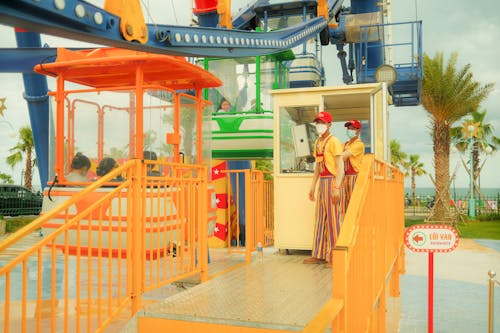 Attendants Standing Near the Entrance of the Ferris Wheel Ride