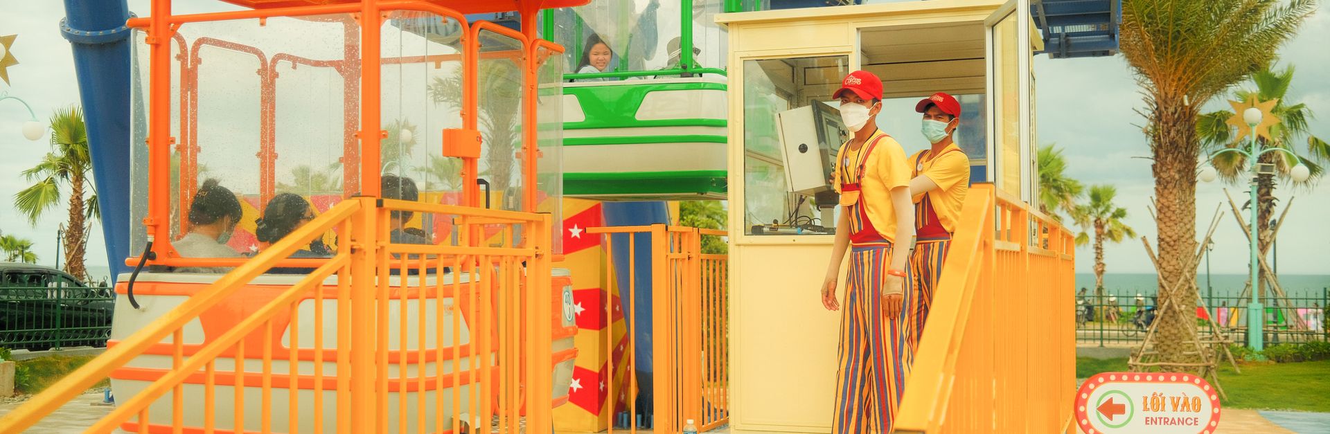 Vibrant outdoor fairground scene with attendants and riders enjoying the amusement ride.