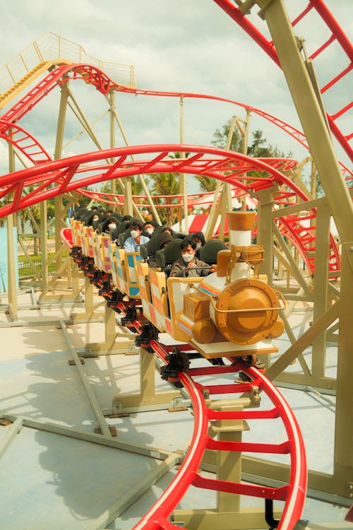 People Riding a Roller Coaster